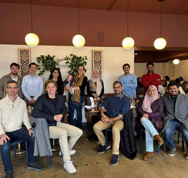 Lab members welcoming Ahilan and Niloy, celebrating Fatemeh's candidacy