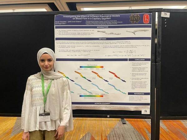 Masah in front of her poster